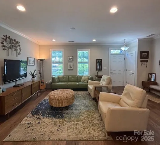 a living room with furniture a rug and a flat screen tv