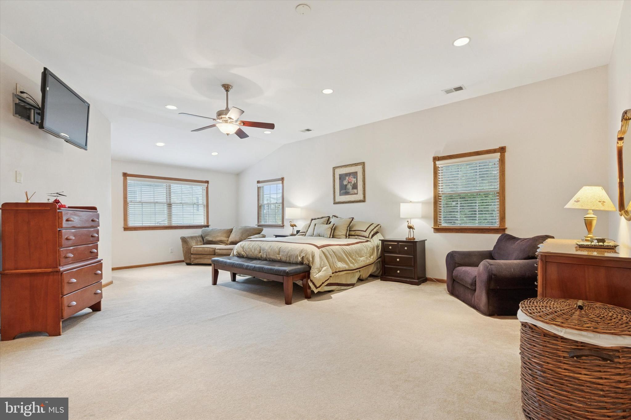 4114 Pilgrim Road Plymouth Meeting, PA 19462 - Photo 17 of 36 a spacious bedroom with a bed a couch and a chandelier