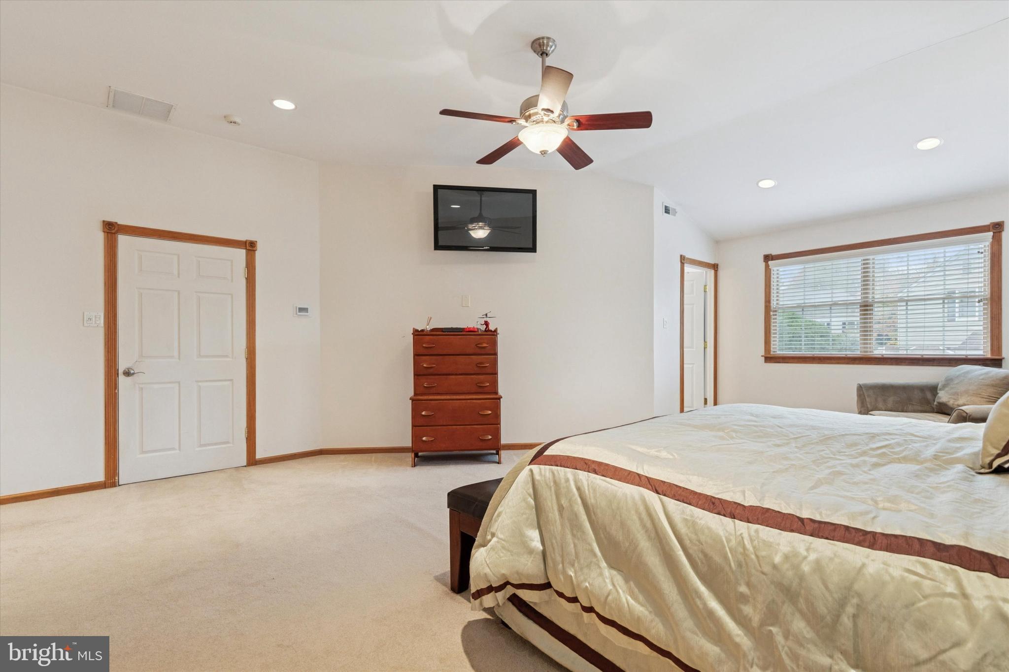 4114 Pilgrim Road Plymouth Meeting, PA 19462 - Photo 18 of 36 a bedroom with a bed a window and a flat screen tv