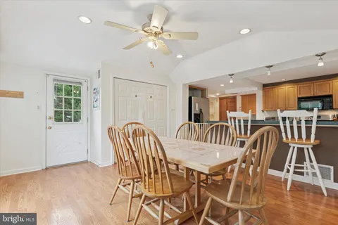 a view of a dining room with furniture and wooden floor