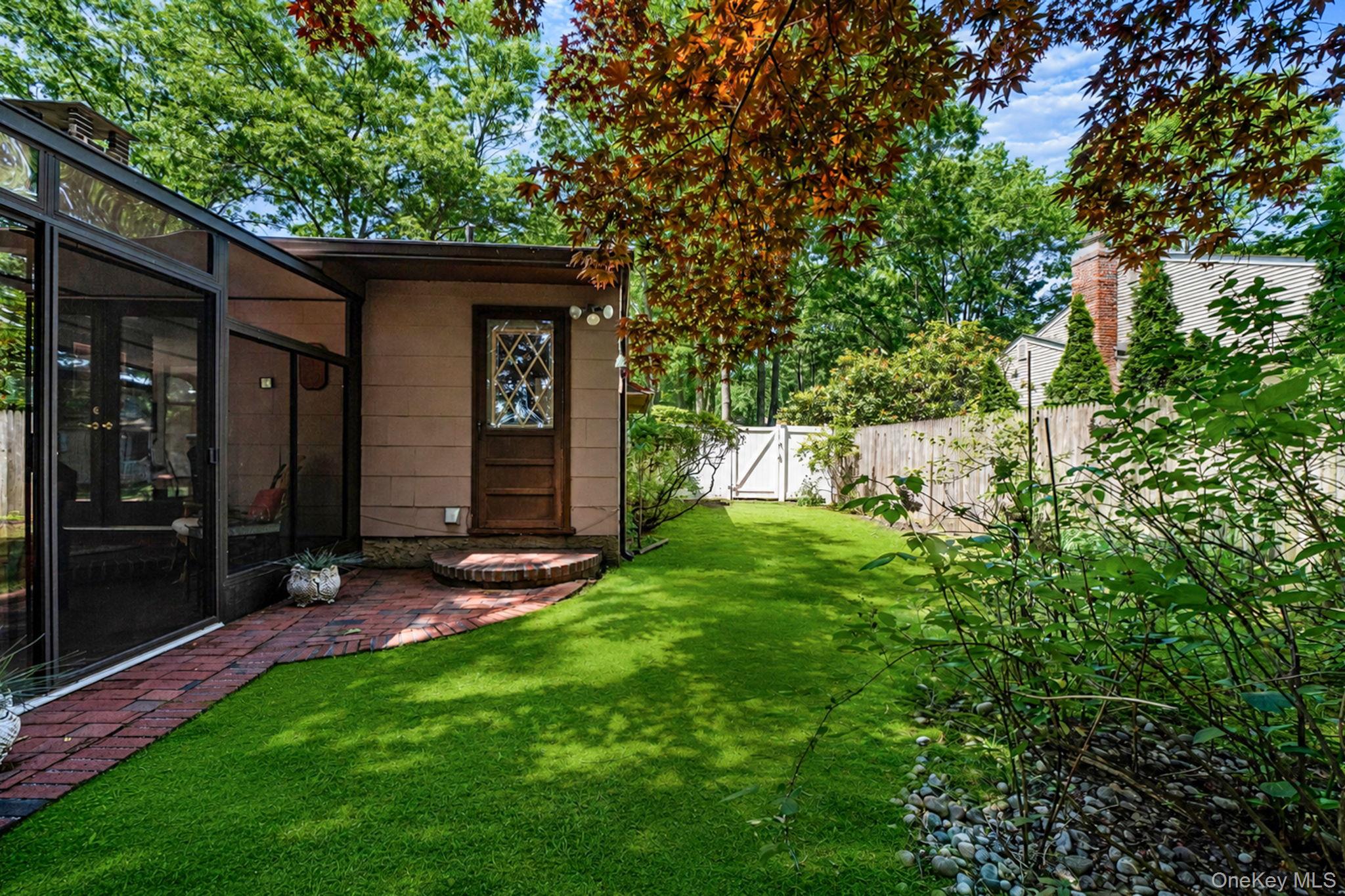 96 Fulton Boulevard Commack, NY 11725 - Photo 5 of 41 a front view of a house with a yard