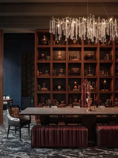 a table with wine bottles and glasses sitting on it