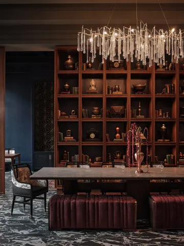 a table with wine bottles and glasses sitting on it