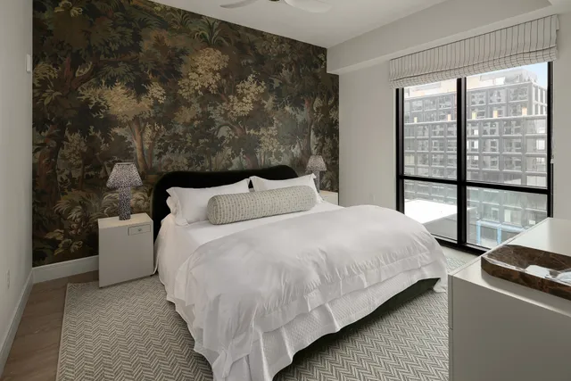 a bed sitting in a bedroom next to a window