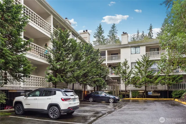 a view of a cars park in front of a building
