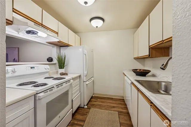 a kitchen with stainless steel appliances granite countertop a sink and a stove