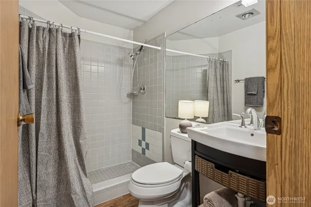 a bathroom with a sink toilet and shower