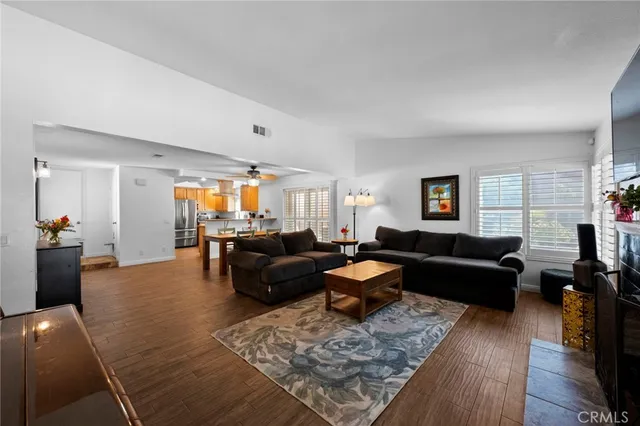 a living room with furniture and wooden floor