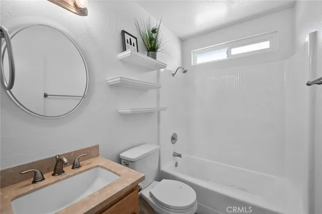 an aerial view of a house with a swimming pool and outdoor seating