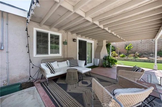 a view of a house with backyard porch and sitting area