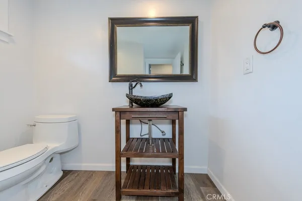 a bathroom with a toilet a sink and mirror