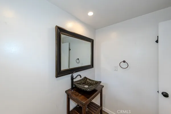 a room with a mirror and a wooden floor