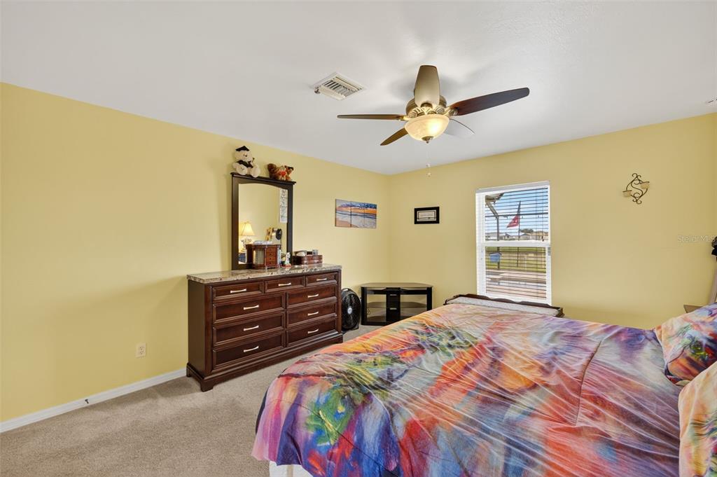 125 Paddock Street Lehigh Acres, FL 33974 - Photo 18 of 45 a bedroom with a bed and a window