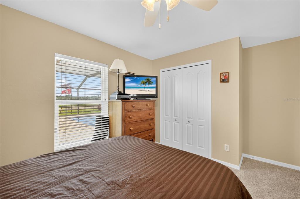 125 Paddock Street Lehigh Acres, FL 33974 - Photo 20 of 45 a bedroom with a bed and wooden floor