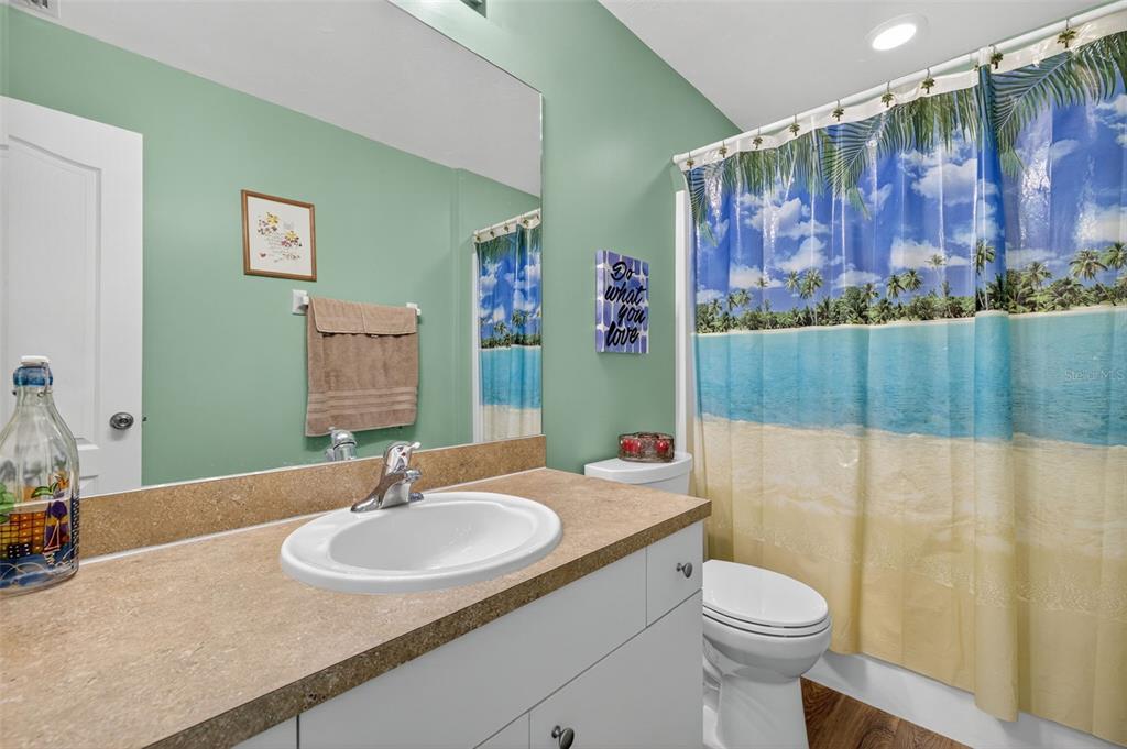 125 Paddock Street Lehigh Acres, FL 33974 - Photo 22 of 45 a bathroom with a sink toilet and shower
