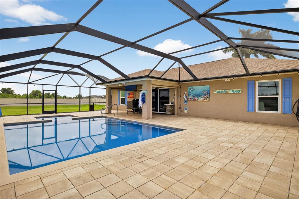 125 Paddock Street Lehigh Acres, FL 33974 - Photo 29 of 45 a view of a swimming pool with a porch