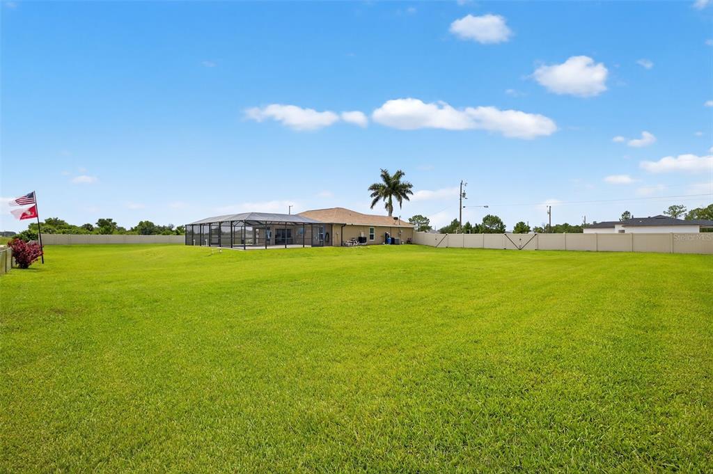 125 Paddock Street Lehigh Acres, FL 33974 - Photo 34 of 45 a view of a lake with houses in the back
