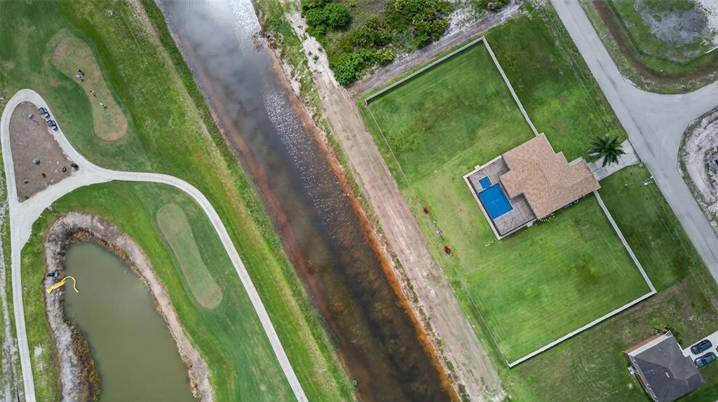 125 Paddock Street Lehigh Acres, FL 33974 - Photo 45 of 45 a view of a swimming pool with a backyard