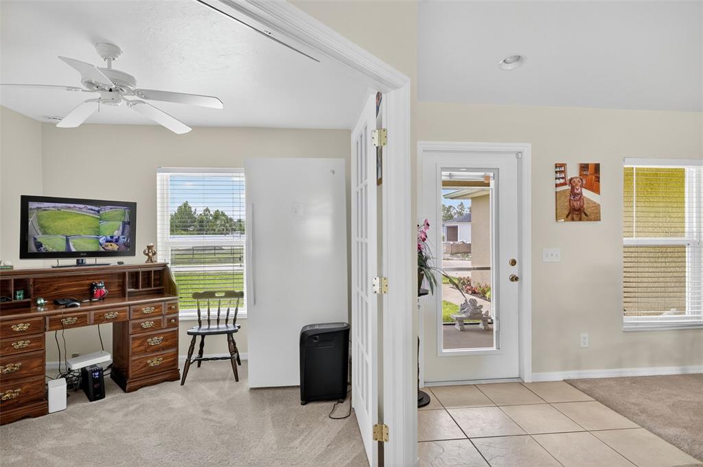 125 Paddock Street Lehigh Acres, FL 33974 - Photo 5 of 45 a living room with furniture and a flat screen tv