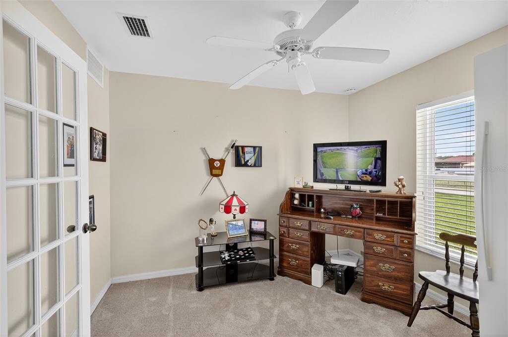 125 Paddock Street Lehigh Acres, FL 33974 - Photo 6 of 45 a living room with furniture and a flat screen tv