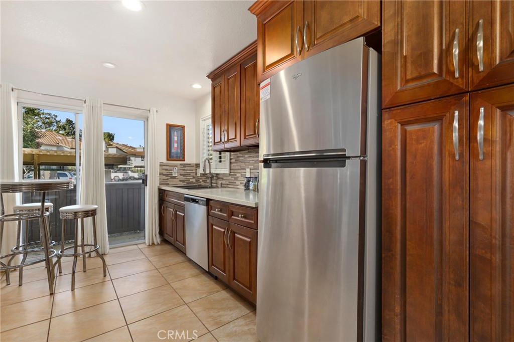 14 Corniche Drive, Unit A Dana Point, CA 92629 - Photo 12 of 49 a kitchen with stainless steel appliances granite countertop a refrigerator and a stove