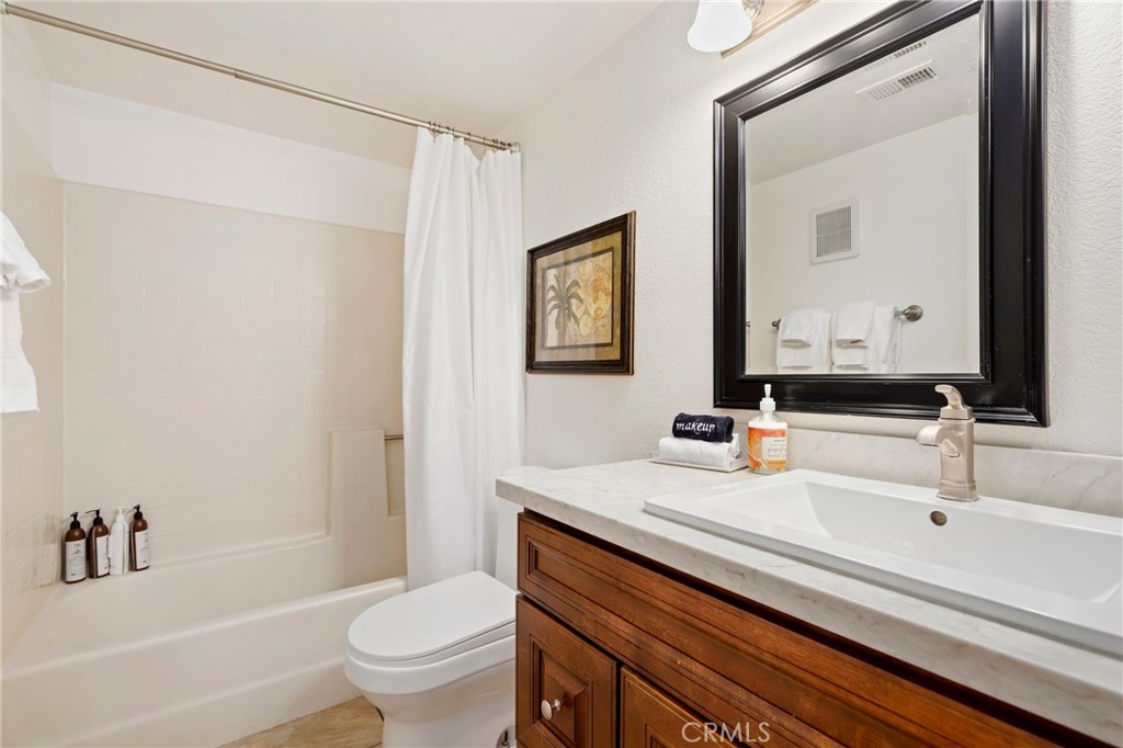 14 Corniche Drive, Unit A Dana Point, CA 92629 - Photo 23 of 49 a bathroom with a sink a toilet and a large mirror