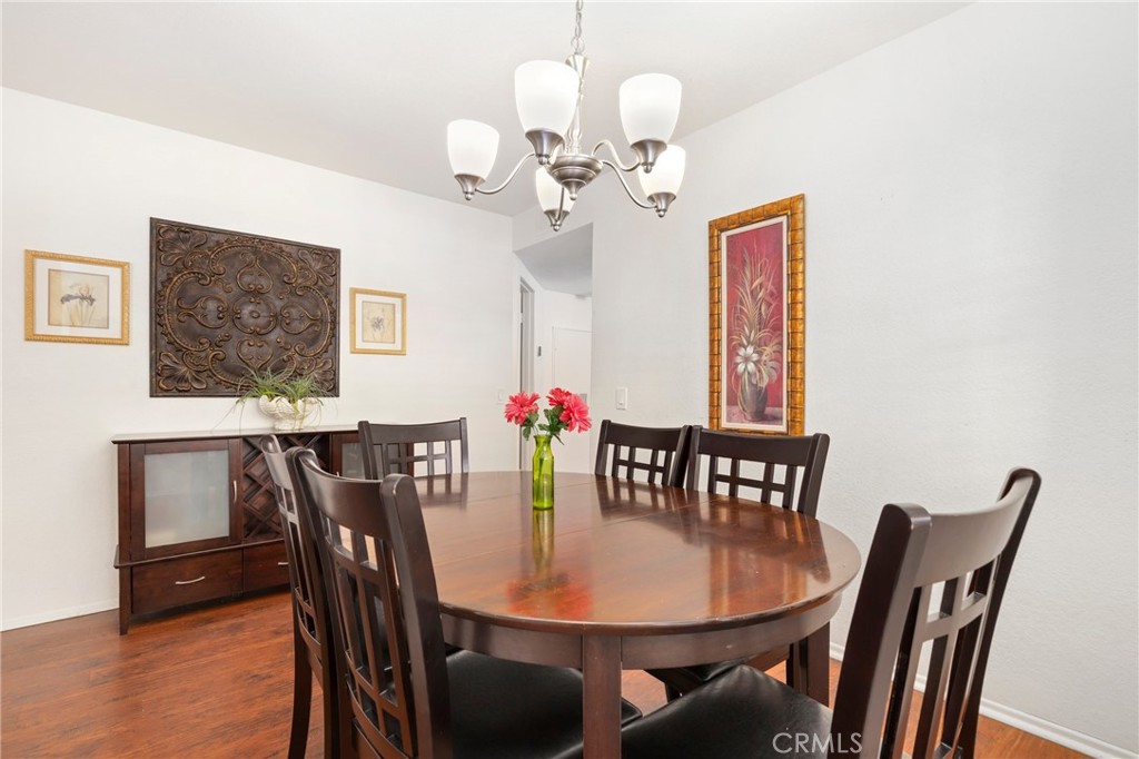14 Corniche Drive, Unit A Dana Point, CA 92629 - Photo 7 of 49 a view of a dining room with furniture wooden floor and a chandelier