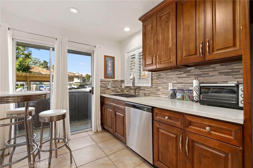 14 Corniche Drive, Unit A Dana Point, CA 92629 - Photo 10 of 49 a kitchen with stainless steel appliances granite countertop wooden cabinets a sink and dishwasher