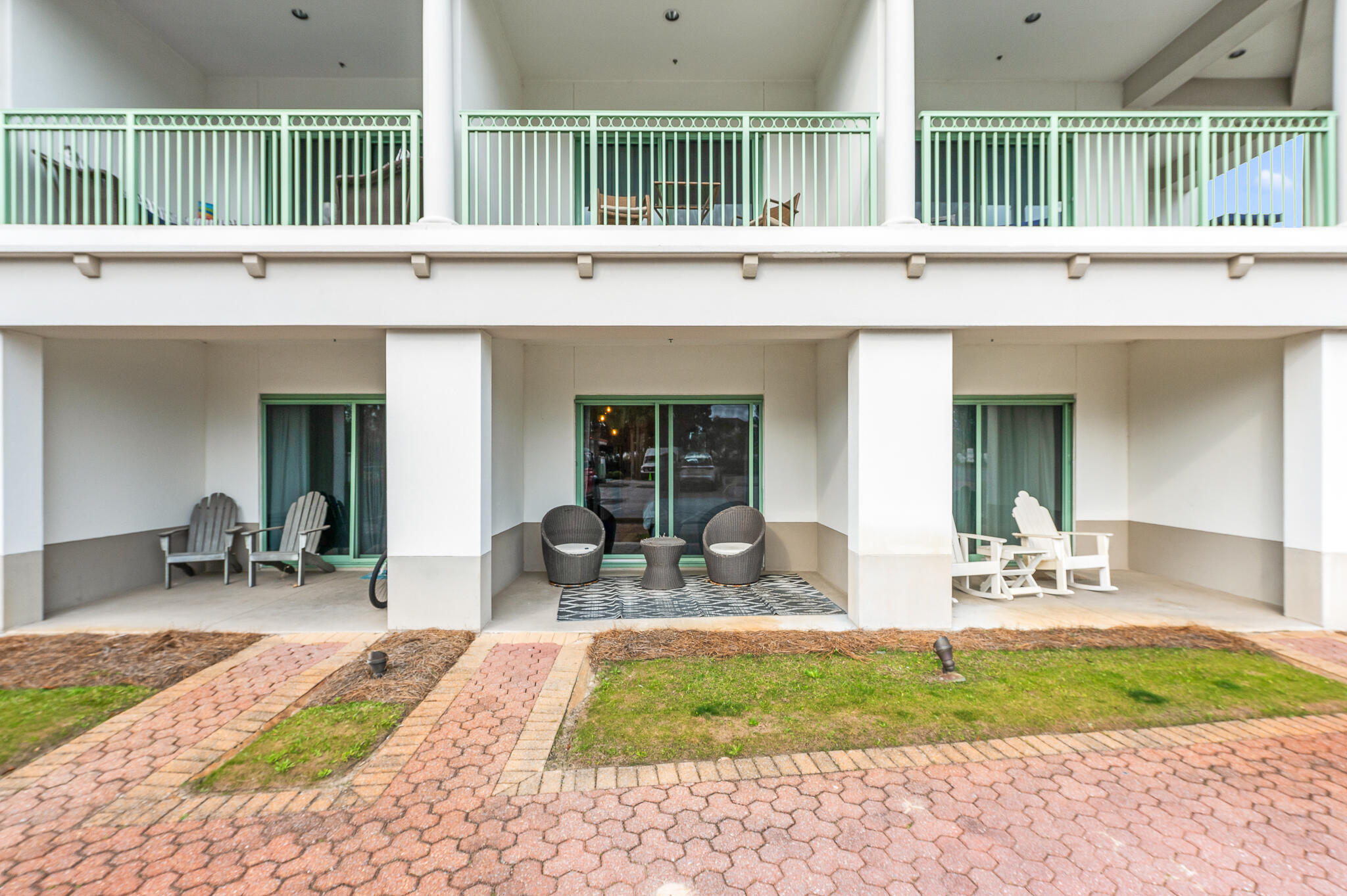 a front view of a house with garden and porch