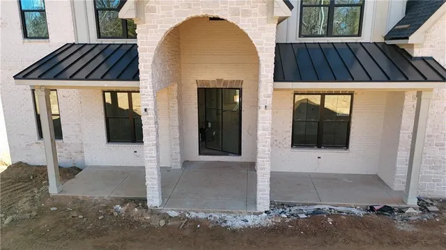 a view of a brick house with many windows