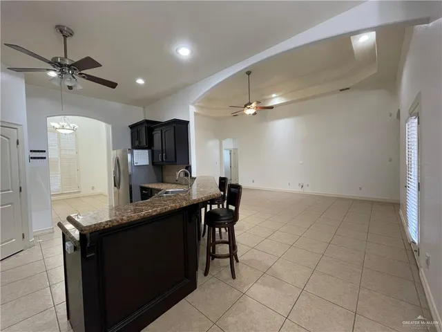 a kitchen with kitchen island a counter top space appliances and cabinets