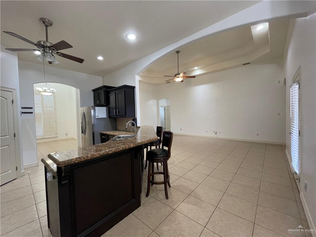 1000 South Flag Street Pharr, TX 78577 - Photo 12 of 24 a kitchen with kitchen island a counter top space appliances and cabinets