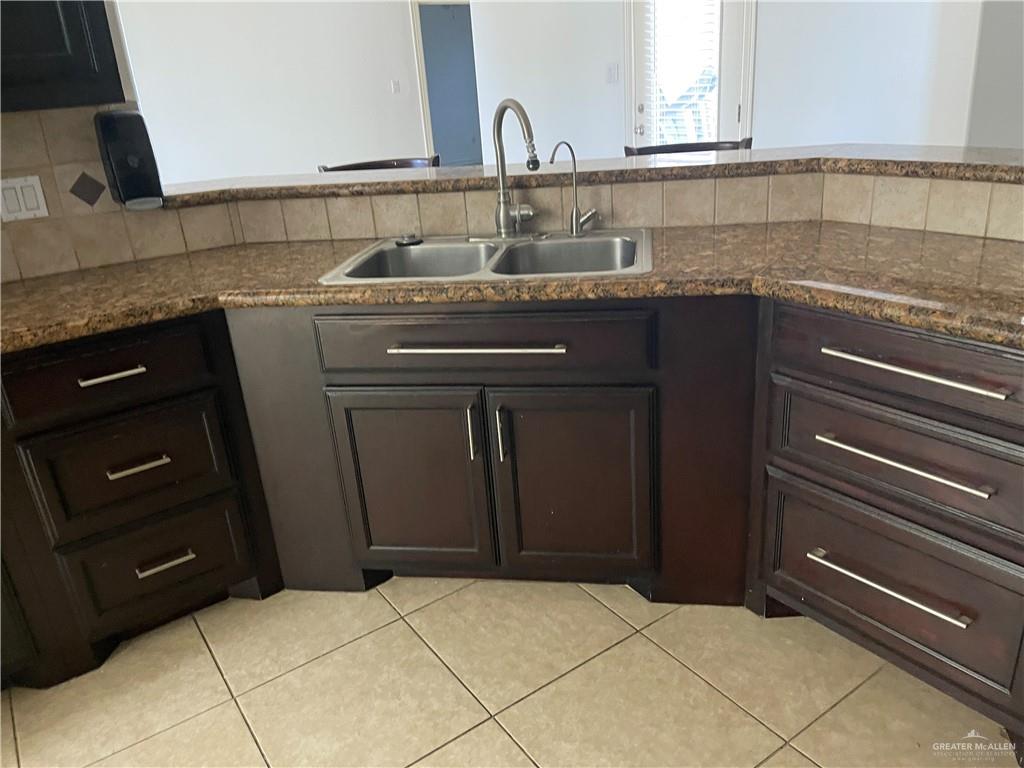 1000 South Flag Street Pharr, TX 78577 - Photo 23 of 24 a kitchen with granite countertop a sink and a stove