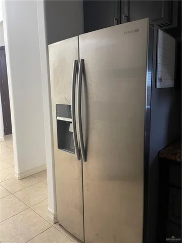 a metallic refrigerator freezer sitting in a kitchen