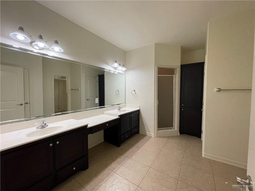1000 South Flag Street Pharr, TX 78577 - Photo 8 of 24 a spacious bathroom with a double vanity sink and a mirror