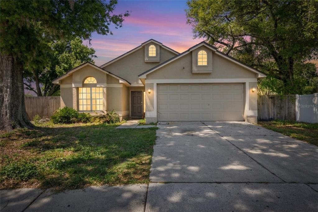 1841 Candlestick Court Lutz, FL 33559 - Photo 1 of 1 a front view of a house with a yard and garage