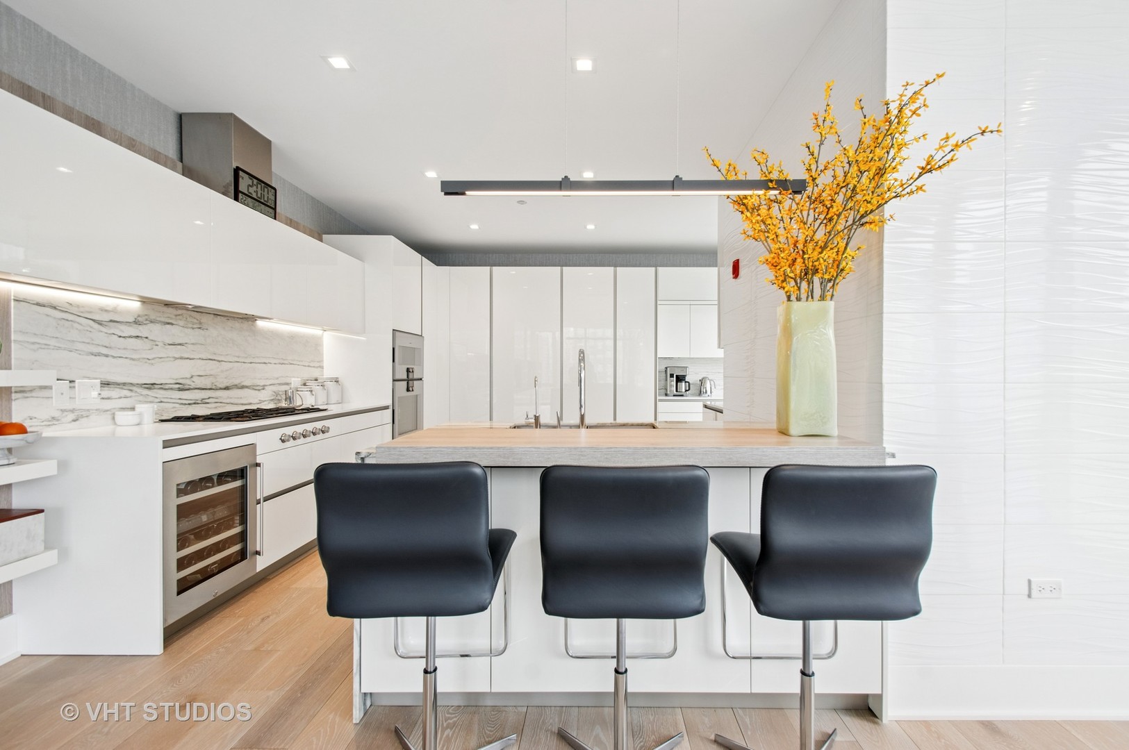 363 East Wacker Drive, Unit 1302 Chicago, IL 60601 - Photo 8 of 31 a kitchen with stainless steel appliances granite countertop a table chairs sink and cabinets