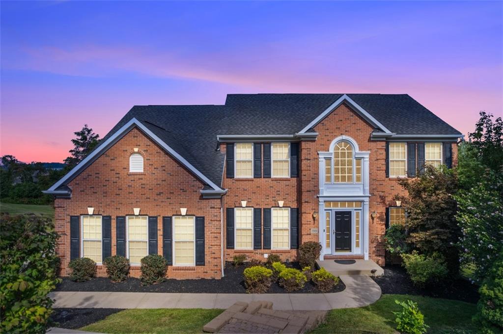 a front view of a house with yard