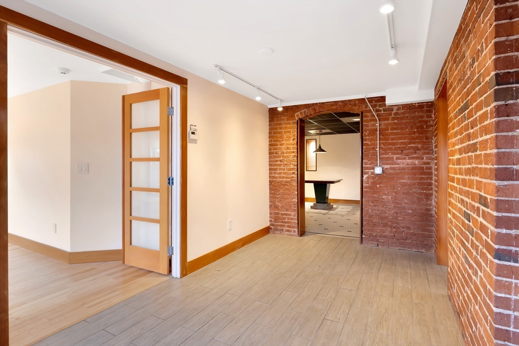 61 Crescent Street, Unit 8 Northampton, MA 01060 - Photo 11 of 30 a view of a hallway with wooden floor and a bathroom