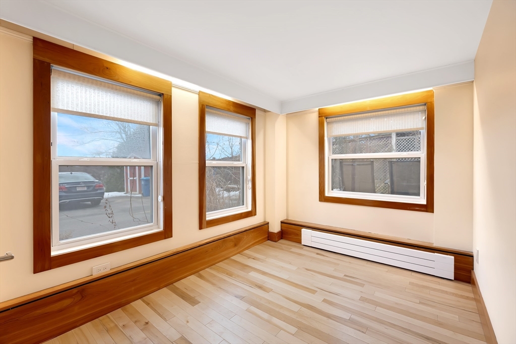 61 Crescent Street, Unit 8 Northampton, MA 01060 - Photo 13 of 30 a view of an empty room with a window and wooden floor