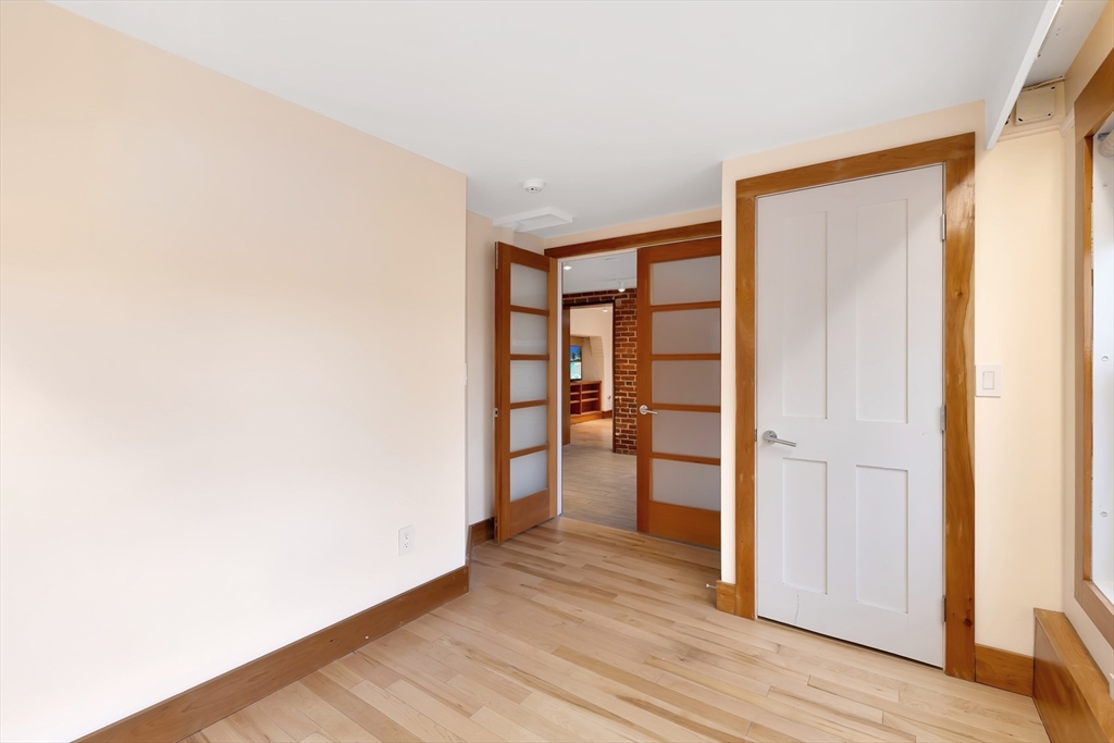 61 Crescent Street, Unit 8 Northampton, MA 01060 - Photo 14 of 30 a view of empty room with wooden floor and fan