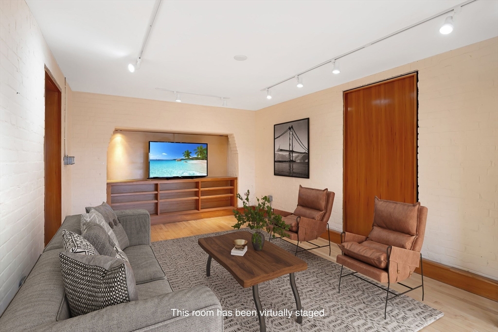 61 Crescent Street, Unit 8 Northampton, MA 01060 - Photo 15 of 30 a living room with furniture and a flat screen tv