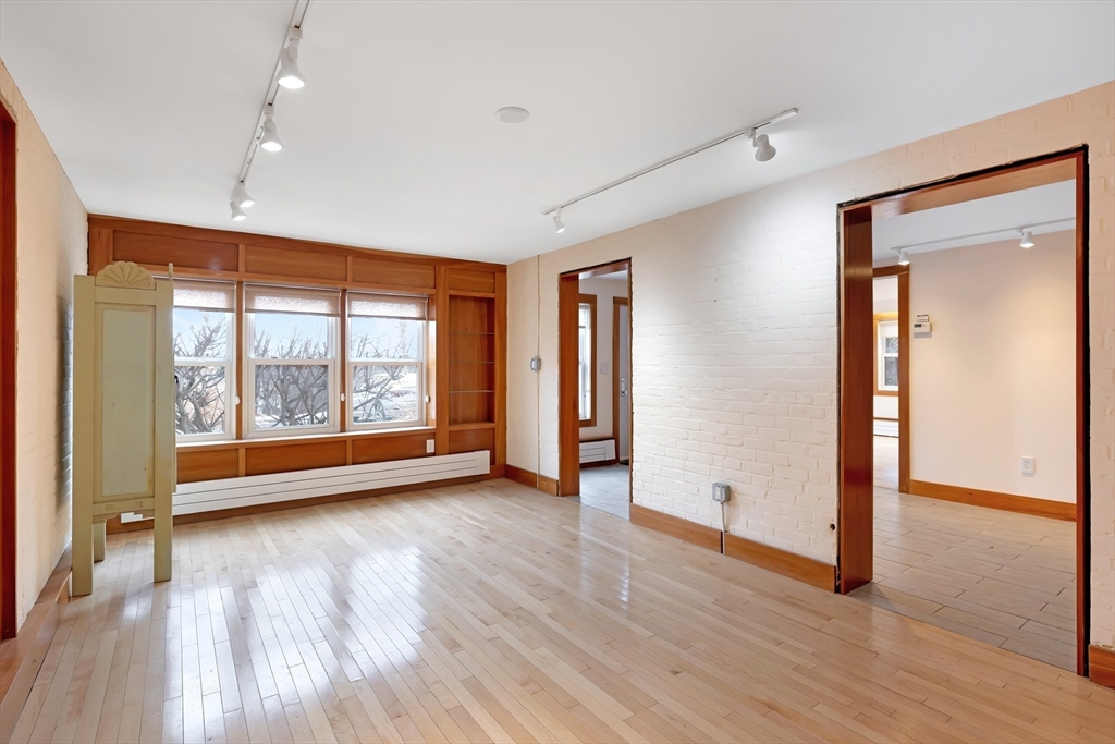 61 Crescent Street, Unit 8 Northampton, MA 01060 - Photo 18 of 30 an empty room with wooden floor and windows