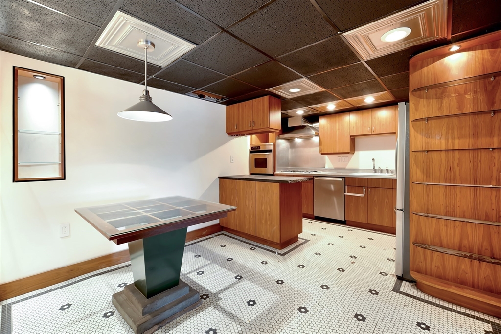 61 Crescent Street, Unit 8 Northampton, MA 01060 - Photo 20 of 30 a kitchen with stainless steel appliances a stove a sink and a refrigerator