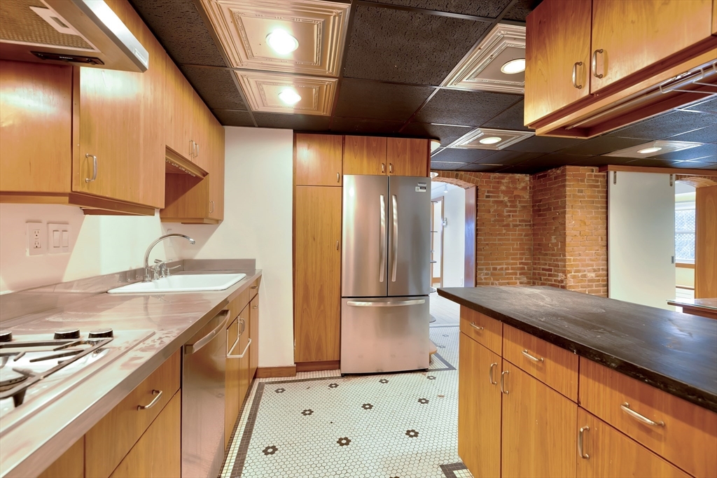 61 Crescent Street, Unit 8 Northampton, MA 01060 - Photo 23 of 30 a kitchen with a sink a stove and cabinets