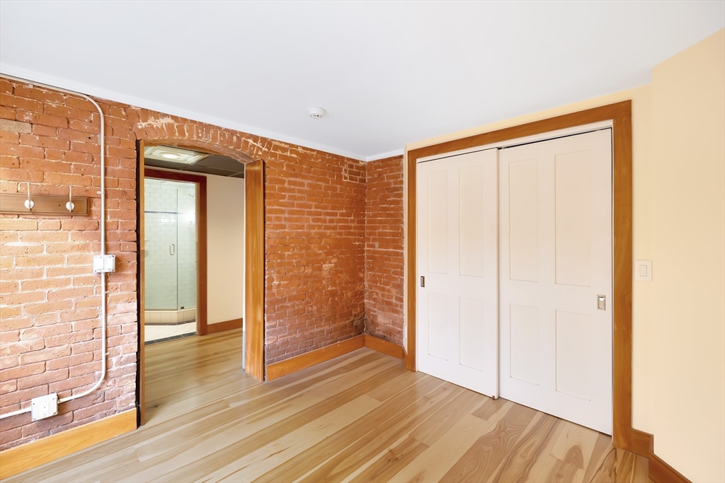 61 Crescent Street, Unit 8 Northampton, MA 01060 - Photo 27 of 30 a view of a hallway with wooden floor and closet