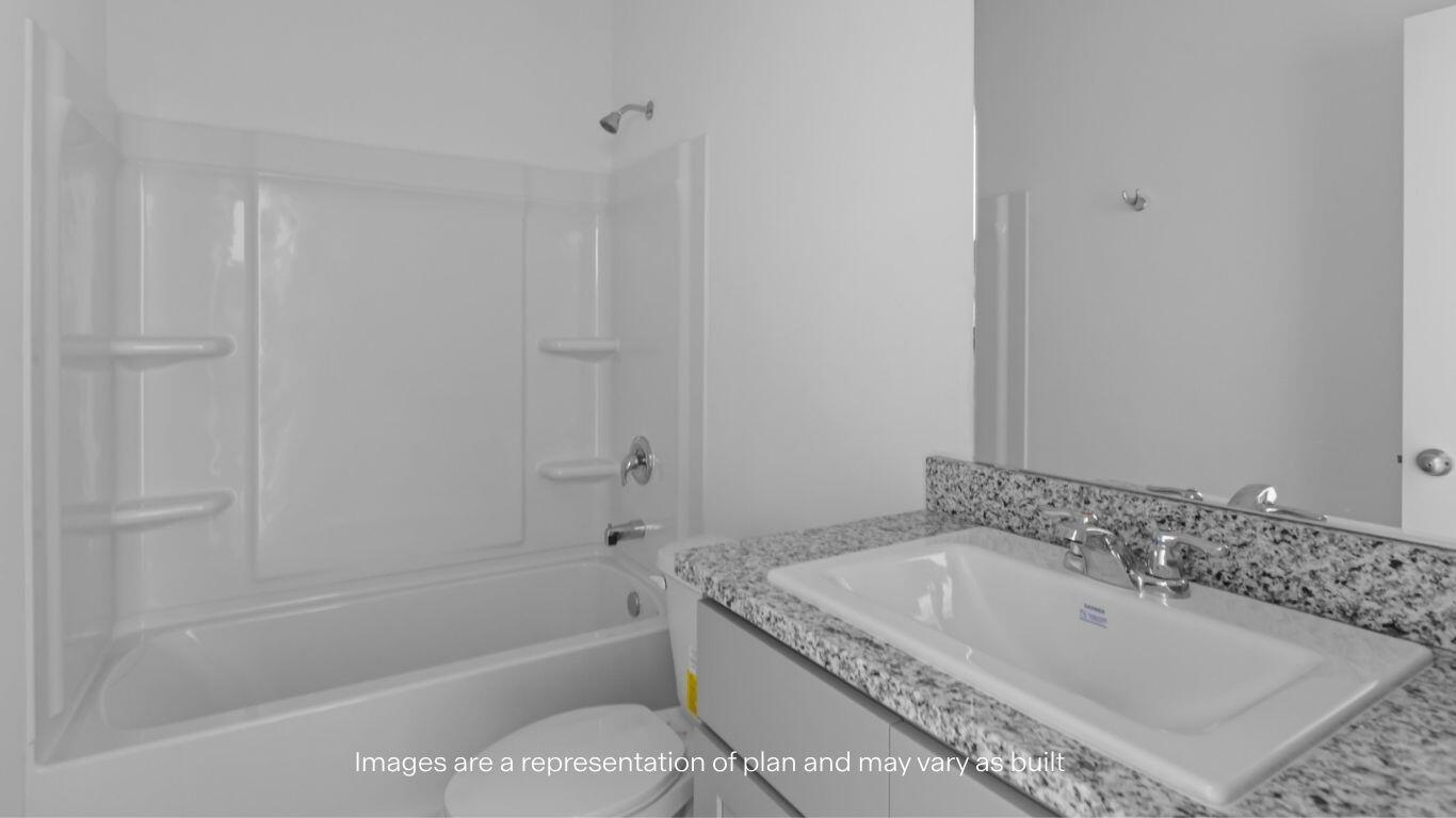 2228 150th Place Lubbock, TX 79423 - Photo 17 of 19 a bathroom with a granite countertop sink a toilet and bathtub