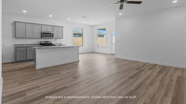 a view of kitchen with sink microwave and stove