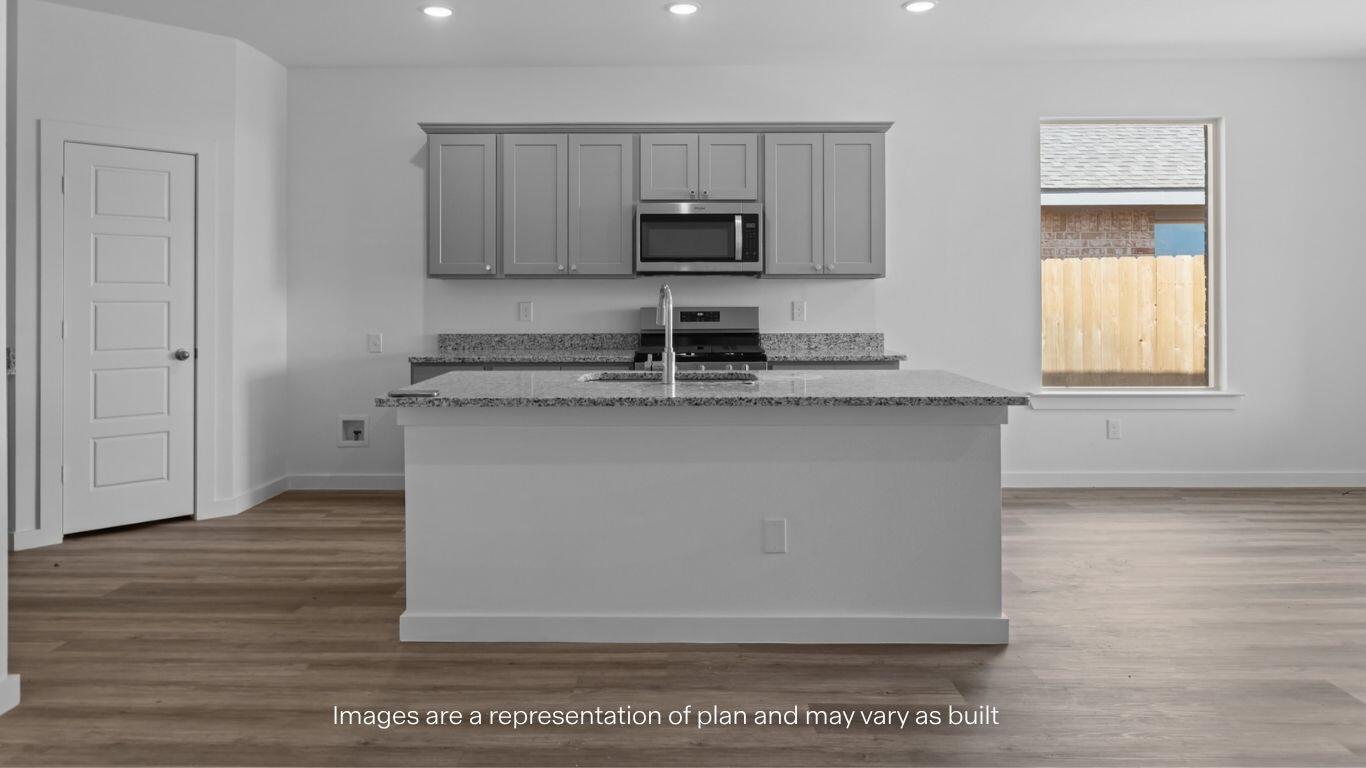 2228 150th Place Lubbock, TX 79423 - Photo 6 of 19 a kitchen with stainless steel appliances granite countertop a sink and a stove