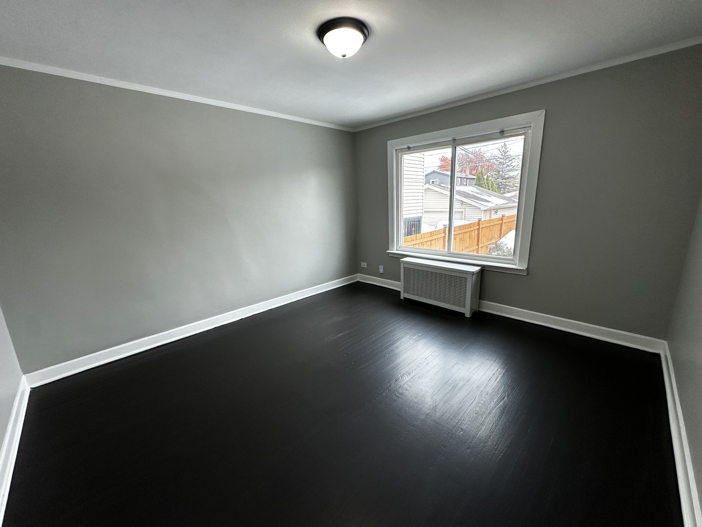 6549 South Keeler Avenue Chicago, IL 60629 - Photo 11 of 16 an empty room with wooden floor and windows